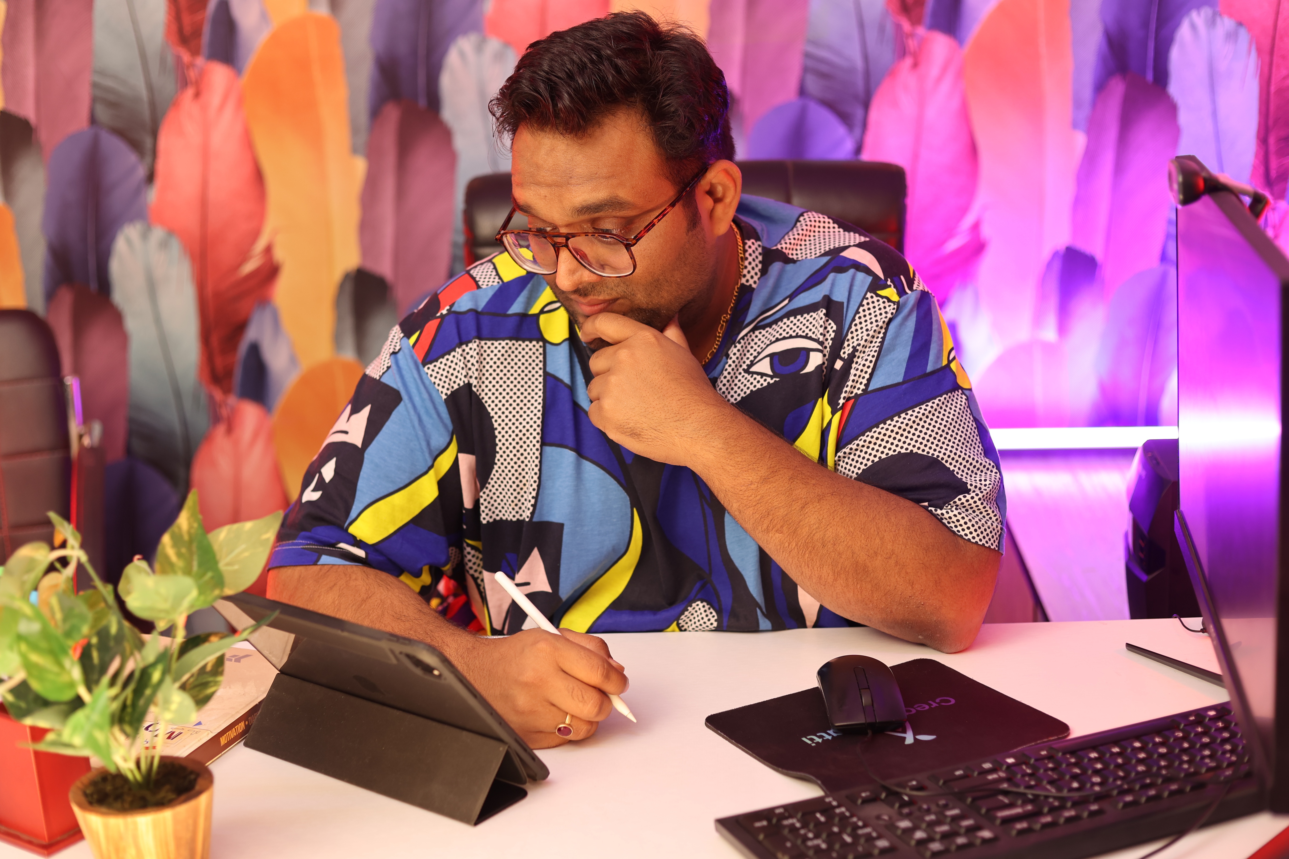 Person sketching a design on a tablet with a stylus