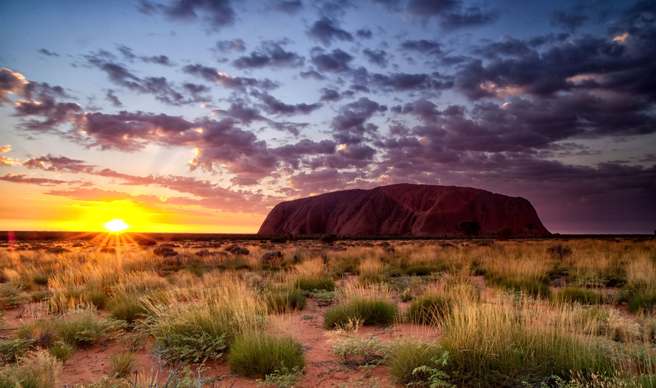 Sunset over Uluru, a classic Australian postcard image