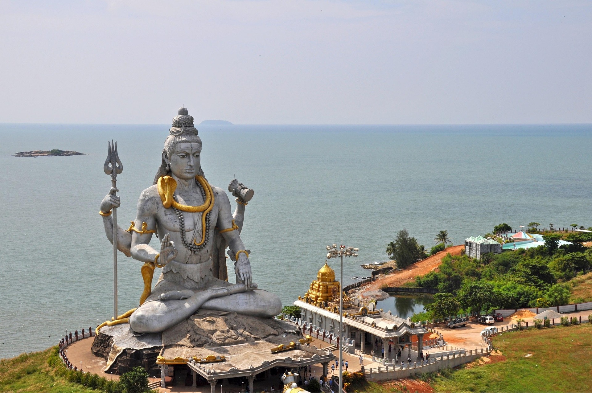 A giant statue of the Hindu god Shiva overlooking the sea